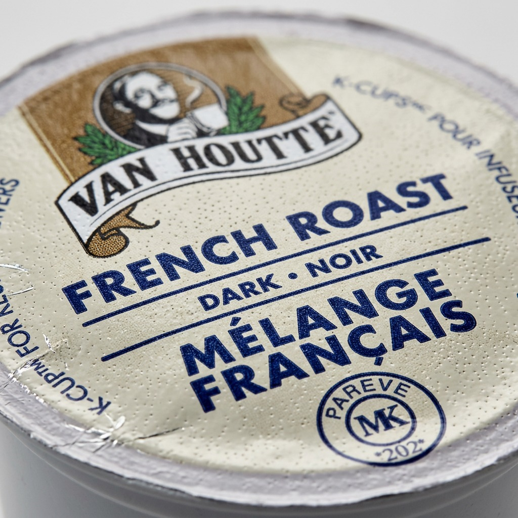 Macro detail of a Van Houtte coffee K-Cup showing the textured foil lid and printed label.