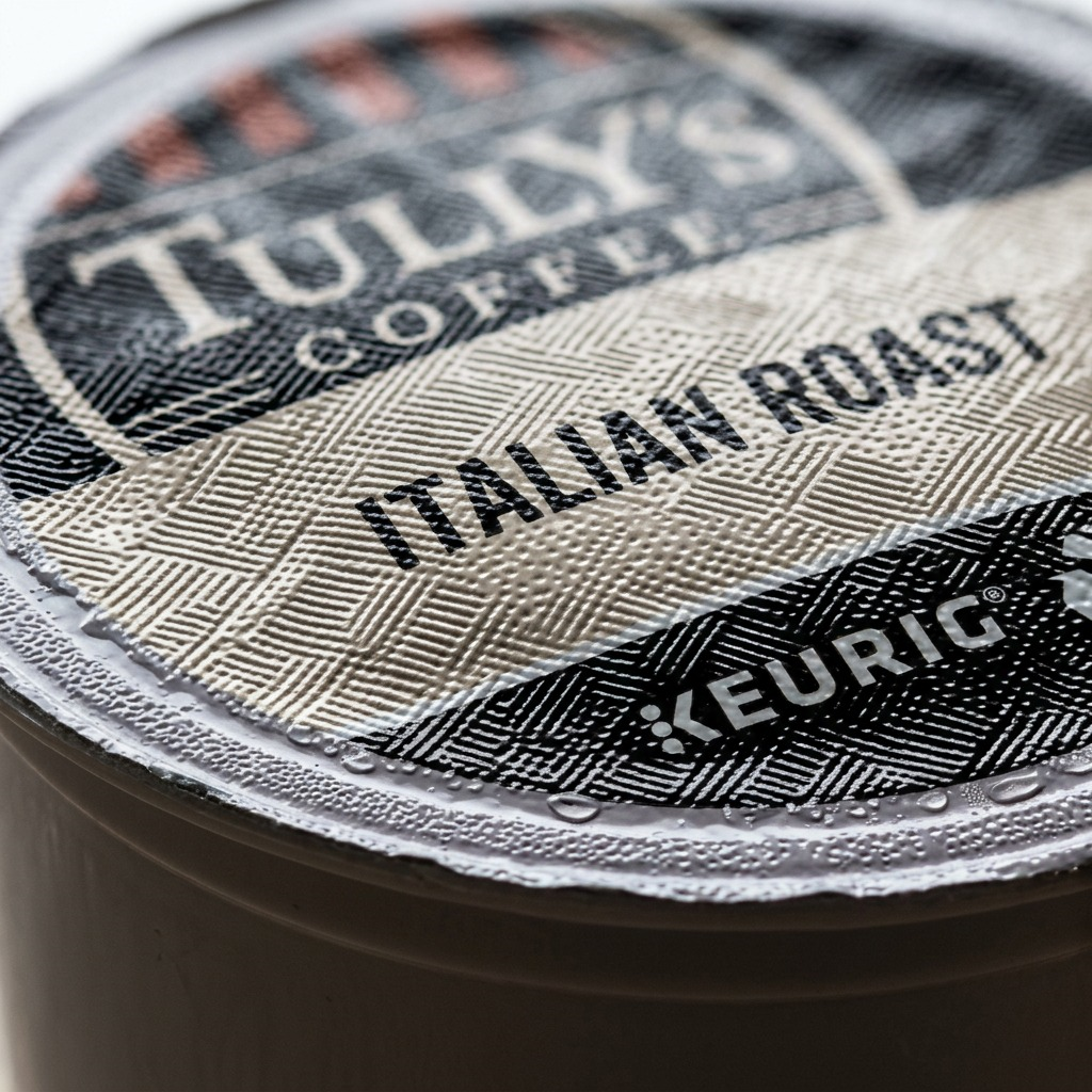 Macro close-up of textured foil lid on Tully's Coffee Italian Roast Keurig K-Cup pod.